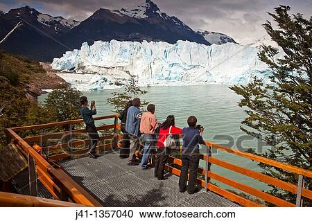 Tourists view Perito Moreno glacier front from platform, Parque Nacional Los Glaciares, Patagonia, Argentina. View Large Photo Image Stock Image - Tourists view Perito Moreno glacier front from platform, Parque Nacional Los Glaciares, Patagonia, Argentina.. Fotosearch