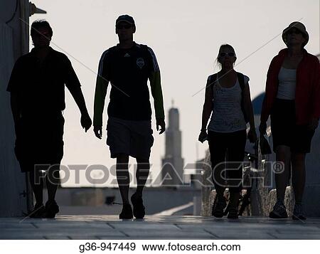 Stock Photo - Tourists walk in Oia, Santorini, Greece. Fotosearch