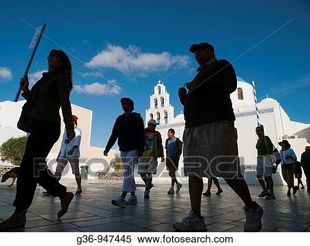 Tourists walk in Oia, Santorini, Greece View Large Photo Image Stock Photography - Tourists walk in Oia, Santorini, Greece. Fotosearch