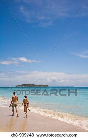 Stock Photo - Tourists walking along beach, Cayos Zapatillas (Zapatillas Keys), Bocas del Toro Province, Panama. Fotosearch