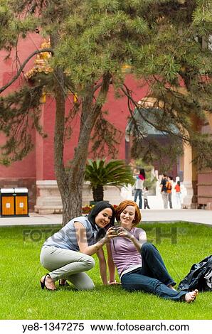 Tourists watching pictures in their camera, The Forbidden City, Beijing, China, Asia MR View Large Photo Image Stock Photography - Tourists watching pictures in their camera, The Forbidden City, Beijing, China, Asia MR. Fotosearch