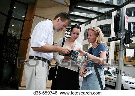 Tourists with guide book at Australia Square, Bond St., Sydney, New South Wales, Australia. View Large Photo Image Stock Photograph - Tourists with guide book at Australia Square, Bond St., Sydney, New South Wales, Australia.. Fotosearch