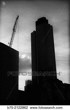 Tower 42 building at sunset and a building under construction with a crane in the city of London, England, UK, Europe View Large Photo Image Stock Image - Tower 42 building at sunset and a building under construction with a crane in the city of London, England, UK, Europe. Fotosearch