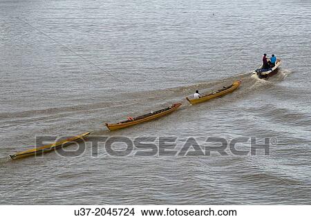 Towing racing boats at Sarawak River, Malaysia. View Large Photo Image Picture - Towing racing boats at Sarawak River, Malaysia.. Fotosearch