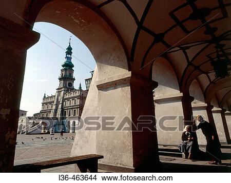 Town square and town hall with two old women gossiping. Famous town because of its Renaissance architecture. Zamosc. Poland. View Large Photo Image Picture - Town square and town hall with two old women gossiping. Famous town because of its Renaissance architecture. Zamosc. Poland.. Fotosearch