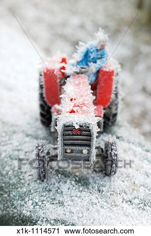 Toy tractor with driver covered in ice cystals View Large Photo Image Stock Image - Toy tractor with driver covered in ice cystals. Fotosearch