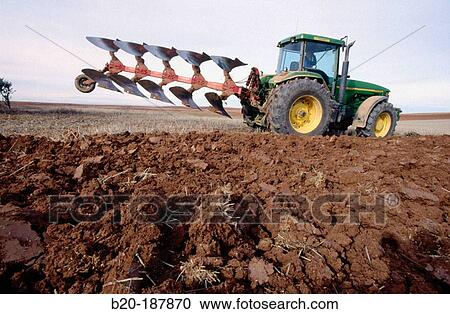 Stock Image - Tractor ploughing field. Spain. Fotosearch