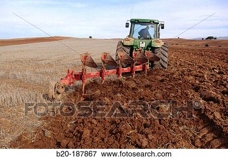 Tractor ploughing field. Spain View Large Photo Image Stock Photo - Tractor ploughing field. Spain. Fotosearch