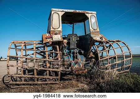 Stock Photo - Tractor with special wheels to work in the rice fields, Ebro Delta, Catalonia, Spain.. Fotosearch