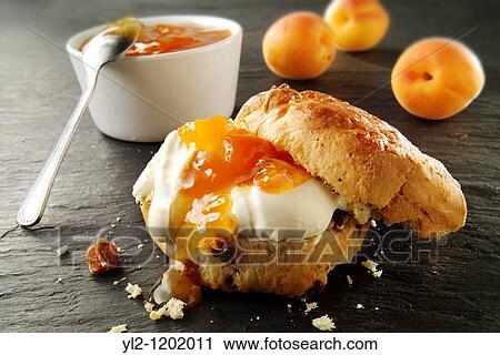 Traditional British scones with clotted cream and apricot jam View Large Photo Image Stock Image - Traditional British scones with clotted cream and apricot jam. Fotosearch