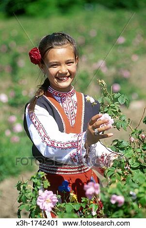 traditional dressed young girl in a rose garden during the Rose Festival in the Rose Valley, Kazanlak, Bulgaria, Europe View Large Photo Image Stock Image - traditional dressed young girl in a rose garden during the Rose Festival in the Rose Valley, Kazanlak, Bulgaria, Europe. Fotosearch