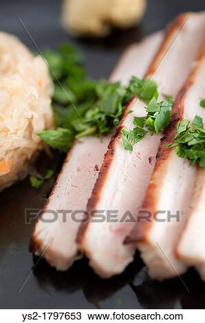 Traditional german food, roasted pork with sauerkraut Served with mustard and parsley View Large Photo Image Stock Image - Traditional german food, roasted pork with sauerkraut Served with mustard and parsley. Fotosearch