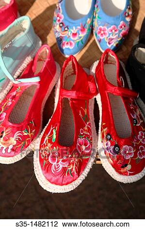 Traditional style hand made embroidered shoes for sale on old town street Town of Guandu Kunming China. View Large Photo Image Stock Image - Traditional style hand made embroidered shoes for sale on old town street Town of Guandu Kunming China.. Fotosearch