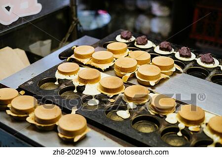 Traditional sweet red bean and cream cakes being made on a iron skillet mold in Taipei, Taiwan. View Large Photo Image Stock Photo - Traditional sweet red bean and cream cakes being made on a iron skillet mold in Taipei, Taiwan.. Fotosearch