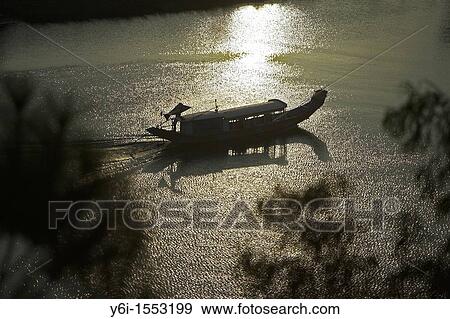 Traditional Vietnamese boat sails up Perfume River passed Vong Canh Hill near Hue central Vietnam View Large Photo Image Stock Photo - Traditional Vietnamese boat sails up Perfume River passed Vong Canh Hill near Hue central Vietnam. Fotosearch