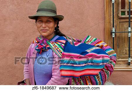 Traditional woman in dress and hat with baby on back in small town of Pisaq Peru View Large Photo Image Stock Photo - Traditional woman in dress and hat with baby on back in small town of Pisaq Peru. Fotosearch
