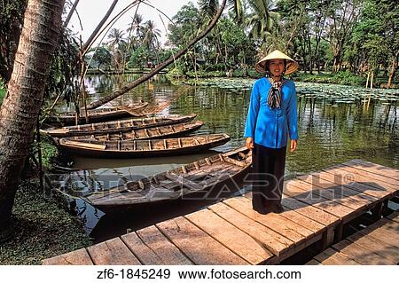 Traditional Woman Near Colorful Old Boats Vietnam Mekong Delta View Large Photo Image Stock Photo - Traditional Woman Near Colorful Old Boats Vietnam Mekong Delta. Fotosearch
