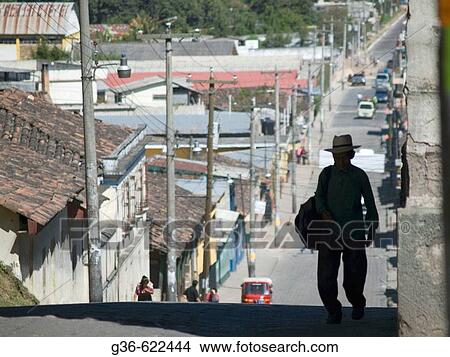 Picture - Traditionally dxressed Guatemalans walk on the streets in Chichicastenango, Guatemala. Fotosearch