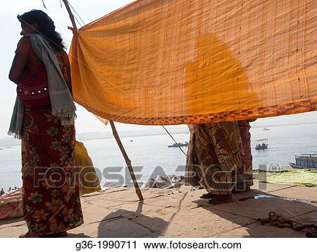Traditionaly dressed women drying clothes at the ghats in Varanasi, Uttar Pradesh, India. View Large Photo Image Stock Image - Traditionaly dressed women drying clothes at the ghats in Varanasi, Uttar Pradesh, India.. Fotosearch