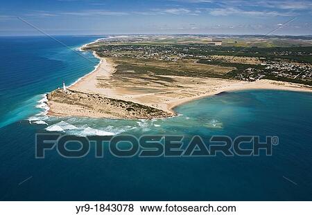 Stock Photo - Trafalgar's lighthouse, Caos de Meca, Zahora beach on the left and Caos's duna on the right, El Palmar and Conil de la Frontera in the back aerial view CBdiz area Spain.. Fotosearch
