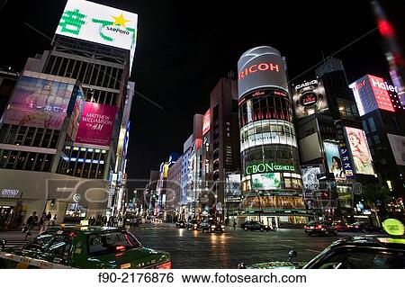 Stock Photograph - Traffic and buildings in the evening in Ginza, Tokyo, Japan.. Fotosearch