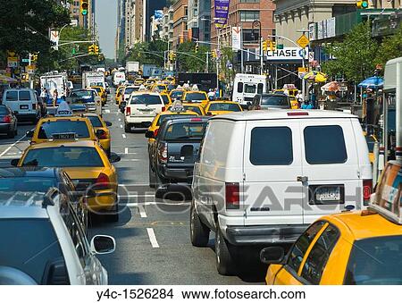 Traffic and pedestrians on crowded city streets in Manhattan in New York City View Large Photo Image Picture - Traffic and pedestrians on crowded city streets in Manhattan in New York City. Fotosearch