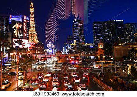 Stock Photo - traffic at night on The Strip, Las Vegas Boulevard South, and a reflection of a hotel. Fotosearch