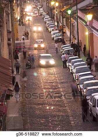 Traffic at twilight on the streets of Antigua, Guatemala View Large Photo Image Stock Photo - Traffic at twilight on the streets of Antigua, Guatemala. Fotosearch