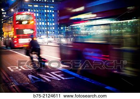 traffic in the city of London. Two double decker bus and a bicycle in motion flowing through the bus lane. London Bridge, London, England, UK, Europe. View Large Photo Image Stock Image - traffic in the city of London. Two double decker bus and a bicycle in motion flowing through the bus lane. London Bridge, London, England, UK, Europe.. Fotosearch