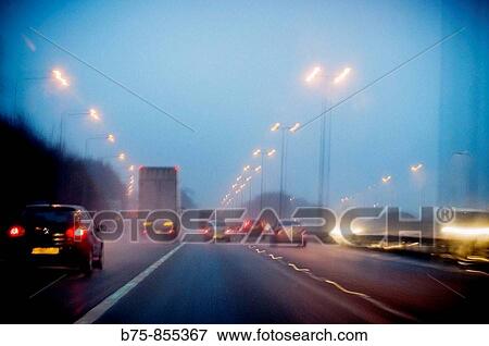 Stock Photo - Traffic in the mist, London, England, UK. Fotosearch
