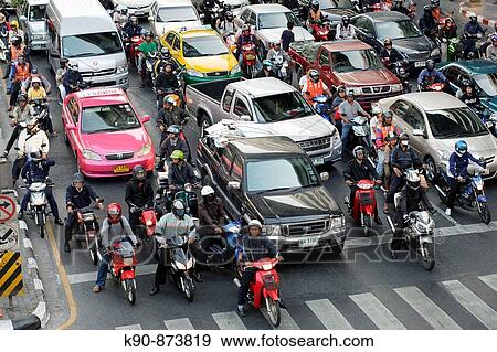 Traffic jam - cars and motorcycle waiting at a red light on Rhatjadamri Road in the centre of Bangkok, Thailand, Southeast Asia View Large Photo Image Stock Photo - Traffic jam - cars and motorcycle waiting at a red light on Rhatjadamri Road in the centre of Bangkok, Thailand, Southeast Asia. Fotosearch