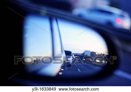 Traffic on highway reflected by side-view mirror at dusk, blurred motion View Large Photo Image Stock Photo - Traffic on highway reflected by side-view mirror at dusk, blurred motion. Fotosearch