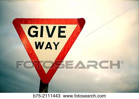 Stock Image - Trafic signal of Give Way with sky in the background. England, UK, Europe.. Fotosearch