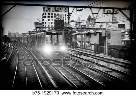 Train and train tracks in the city, DLR, London, England, UK View Large Photo Image Stock Image - Train and train tracks in the city, DLR, London, England, UK. Fotosearch