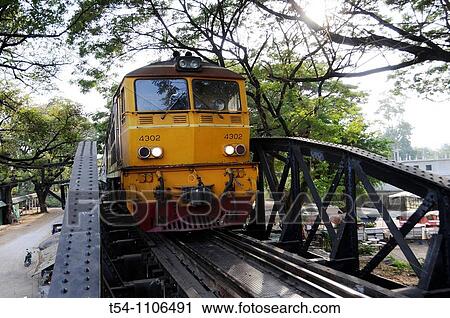 Stock Image - Train cross the River Kwai Bridge in Kanchanaburi. Fotosearch