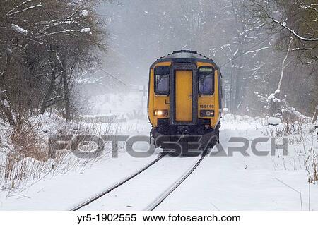 Stock Photography - Train from Whitby to Middlesbrough on the picturesque Esk Valley Line approaching Kildale station in snow Kildale, North York Moors National Park, North Yorkshire, England, United Kingdom. Fotosearch
