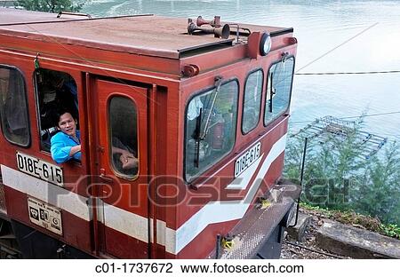 Stock Image - Train locomotive driver at Hai Van pass, Central Vietnam. Fotosearch