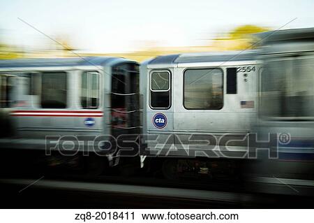 Stock Image - Train moving on the tracks at CTA Station in Chicago.. Fotosearch