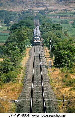 Picture - Train on Railroad track, Ramdarya, Pune, Maharashtra, India. Fotosearch