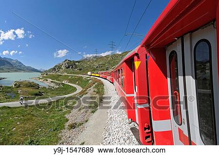 Train ride with Rh? tische Bahn on the Bernina line from Ospizio Bernina to Poschiavo passing the Lago Bianco Switzerland, Western Europe, Graub? nden, Bernina, UNESCO World Heritage site Rhaetien Railway View Large Photo Image Stock Photo - Train ride with Rh? tische Bahn on the Bernina line from Ospizio Bernina to Poschiavo passing the Lago Bianco Switzerland, Western Europe, Graub? nden, Bernina, UNESCO World Heritage site Rhaetien Railway. Fotosearch