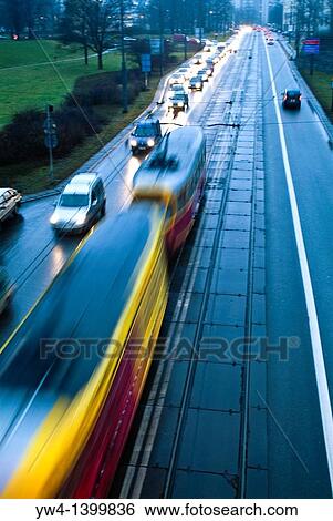Tram at dusk passing on the highway below the Old Town, Warsaw, Poland View Large Photo Image Stock Photograph - Tram at dusk passing on the highway below the Old Town, Warsaw, Poland. Fotosearch