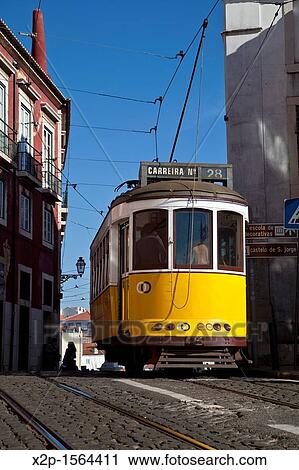 Stock Image - Tram in a street in Alfama district, Lisbon, Portugal, Europe. Fotosearch