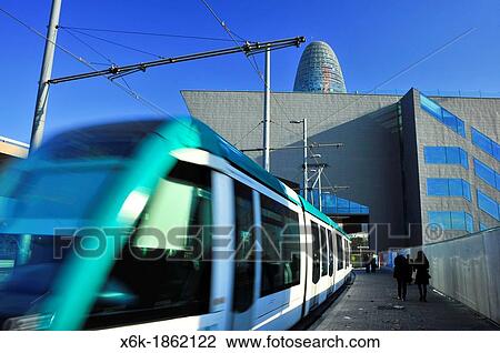Tram passing through the building of the Barcelona Design Hub DHUB, MBM Architects, Glories Square and Agbar tower by Jean Nouvel, 22 @ district, Barcelona, Catalonia, Spain. View Large Photo Image Stock Image - Tram passing through the building of the Barcelona Design Hub DHUB, MBM Architects, Glories Square and Agbar tower by Jean Nouvel, 22 @ district, Barcelona, Catalonia, Spain.. Fotosearch