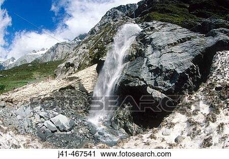 Tramper on avalanche debris. Under waterfall coming off Mt. Sefton. Copland Valley. Near Douglas Rock Hut. South Island. New Zealand. View Large Photo Image Stock Image - Tramper on avalanche debris. Under waterfall coming off Mt. Sefton. Copland Valley. Near Douglas Rock Hut. South Island. New Zealand.. Fotosearch