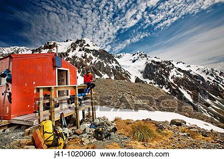 Tramper outside Barker hut as high cloud forms overhead, Arthur's Pass National Park, Canterbury, New Zealand. View Large Photo Image Stock Image - Tramper outside Barker hut as high cloud forms overhead, Arthur's Pass National Park, Canterbury, New Zealand.. Fotosearch