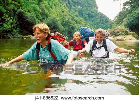 Trampers crossing the Fox River Paparoa National Park New Zealand View Large Photo Image Stock Image - Trampers crossing the Fox River Paparoa National Park New Zealand. Fotosearch