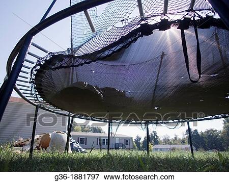 Stock Photo - Trampoline left outside of a foreclosed house in Burlington, North Carolina. Fotosearch