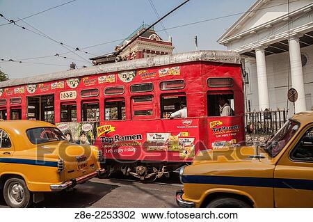 Trams and taxis ply in the busy BBD Bagh area near the red Writers Buildings and St. Andrew's Church, which can be seen partially in the background. View Large Photo Image Stock Image - Trams and taxis ply in the busy BBD Bagh area near the red Writers Buildings and St. Andrew's Church, which can be seen partially in the background.. Fotosearch