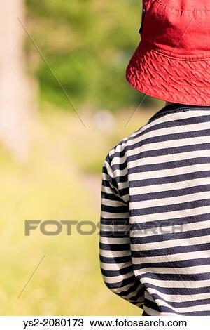 Tranquil summer scene. Young girl with red hat standing outdoors, watching nature. View Large Photo Image Stock Image - Tranquil summer scene. Young girl with red hat standing outdoors, watching nature.. Fotosearch