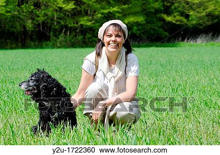 Travel woman with scarf and backpack on the green field with grass and trees and a dog View Large Photo Image Stock Image - Travel woman with scarf and backpack on the green field with grass and trees and a dog. Fotosearch